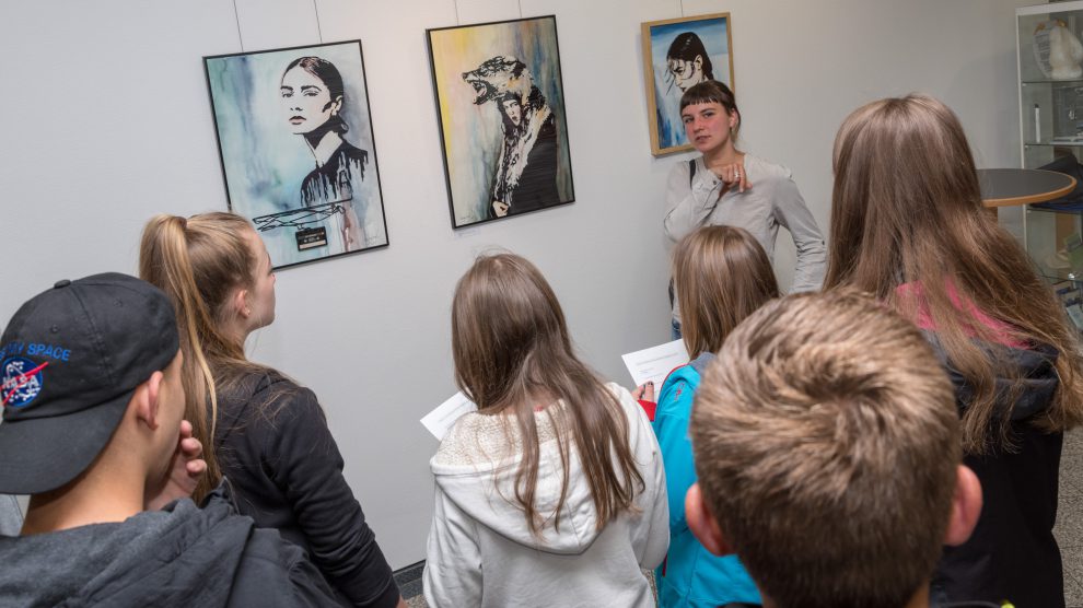 Katrin Lazaruk erläutert den Schülerinnen und Schülern ihre Werke. Foto: Gemeinde Wallenhorst
