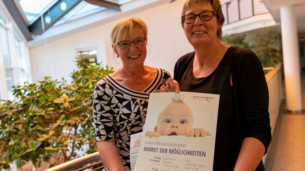 Angelika Uhlen und Kornelia Böert (von links) weisen auf den Markt der Möglichkeiten zum Thema „Frühe Hilfen“ in den Familienzentren hin. Foto: André Thöle