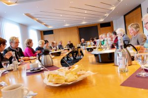 Bei Kaffee und Kuchen dankt Bürgermeister Otto Steinkamp (Mitte) dem ehrenamtlichen Team der Hollager Tafel. Foto: Gemeinde Wallenhorst / André Thöle﻿