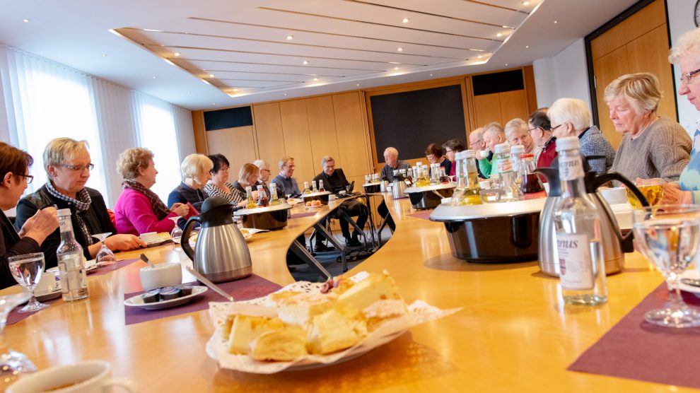 Bei Kaffee und Kuchen dankt Bürgermeister Otto Steinkamp (Mitte) dem ehrenamtlichen Team der Hollager Tafel. Foto: Gemeinde Wallenhorst / André Thöle﻿