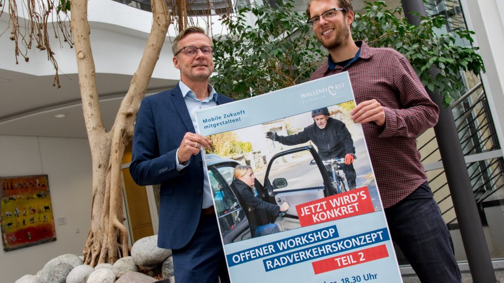 Bürgermeister Otto Steinkamp und Stefan Sprenger weisen auf den zweiten Workshop zum Radverkehrskonzept hin. Foto: Gemeinde Wallenhorst / André Thöle