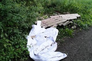 An einem Waldweg im Bereich Bramheide / Zum Ickerkolk entsorgten Unbekannte illegal Faserzementplatten und weiße Kunststofffolien. Foto: Polizei