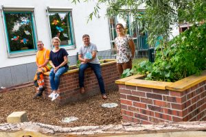 Josef Nölker (Baubetriebshof), Anne Frey, André Schwegmann (Förderverein) und Isabella Draber (von links) im fertiggestellten Schulgarten. Foto: André Thöle / Gemeinde Wallenhorst