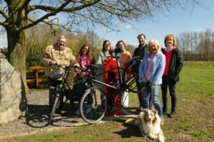 Präsentieren an der „Vehrter Meile“ in Belm die neuen Fahrrad-Reparatur- und Servicestationen in der VarusRegion im Osnabrücker Land, von rechts: Angelika Hoffstädt (Tourismusgesellschaft Osnabrücker Land), Anette Lange (Bohmte, mit Regions-Maskottchen Cooper), Stefan Brune (Wallenhorst), Christiane Wagner (Stadtmarketing Bramsche), Nadine Levermann (Tourist-Info Bad Essen), Maike Schlichting (Ostercappeln) und Dirk Meyer (Belm). Foto: VarusRegion im Osnabrücker Land